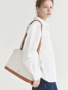 Editor's Notevey presents a bag that can be worn with any style from office look to casual look.- Three dimensional silhouette- Simple designed canvas bag- Good to wear it with thick outer- Inner open pocket and zipper pocketMeasurements (in.)- Size: 13.98 in. * 9.84 in. * 4.13 in.- Strap Length: 0.79 in. * 27.56 in.Composition & Care- Upper: Cotton Canvas, Lining: Cotton- Do not wash- Professional cleaning is neededDesigner- by vey Daily Use Cotton Satchel, Everyday Versatile Double Handle Canvas Bag, Versatile Office Satchel With Leather Handles, Versatile Everyday Canvas Satchel Bag, Versatile Everyday Canvas Bags, Everyday Canvas Satchel Bag With Zipper Pocket, Modern Canvas Bag With Zipper Pocket For Everyday, Versatile Beige Canvas Bag For Everyday Use, Versatile Canvas Bag With Zipper Pocket