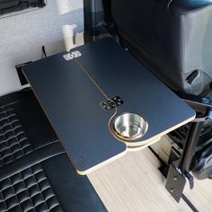 a table with a metal bowl on it in the back of a truck or van