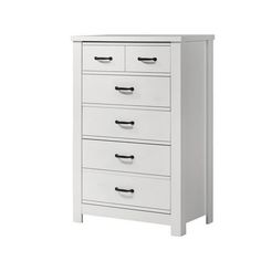 a white dresser with four drawers on it