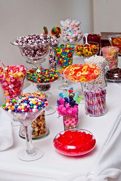 a table topped with lots of different types of candies and desserts on top of it