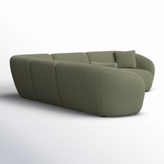 a green couch sitting on top of a white floor