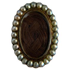 Step into the past with this exquisite antique Victorian mourning brooch, crafted in 14k yellow gold and adorned with natural pearls. This brooch is a poignant reminder of the Victorian era's sentimental jewelry, featuring a unique design that encases a woven hair memento. The lustrous pearls framing the centerpiece add a touch of elegance and reverence. Perfect for collectors and those who appreciate historical jewelry, this piece offers a glimpse into the intimate and personal traditions of th Victorian Hair Locket, Victorian Hair Accessories, Victorian Hair Jewelry, Historic Jewelry, Beach Waves For Short Hair, Sentimental Jewelry, Hair Locket, Elegant Brooch, Victorian Hair