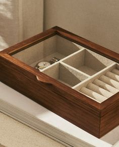 an open wooden box containing several compartments