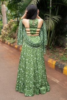 Olive green attached cancan lehenga with all over floral print. Paired with a padded blouse with matching print and hand embroidered with pearls, mirrors and glass beads and dupatta with matching print and sequin embroidered scallop border. - Aza Fashions Green Lehenga With Tilla For Reception, Green Palazzo Set With Unstitched Blouse For Wedding, Green Palazzo Set With Unstitched Blouse For Reception, Green Cutdana Pre-draped Saree Floor-length, Green Floor-length Pre-draped Saree With Cutdana, Green Palazzo Set With Unstitched Blouse For Festivals, Green Tilla Sharara For Festivals, Green Sharara With Tilla For Festive Occasions, Festive Green Sharara With Tilla Details