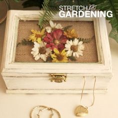 a white box with flowers and two gold rings