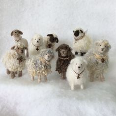 a group of stuffed animals standing next to each other on a snow covered ground,