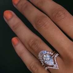 a woman's hand with an engagement ring on it