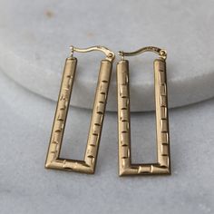 These large rectangle earrings feature diamond-cut etching on both sides and have been crafted in 10k yellow gold. Wonderfully unique, these earrings are a true attention grabber and suitable for any occasion! Measure approx. 40 mm (long) x 15 mm (wide) each, 3.7g Metals: Solid 10k yellow gold  Please allow up to 5 business days for processing. Currently only shipping within Canada and the US. | c u r a t e d | Visit our website for curated and modern pieces  https://www.menkduke.com | f a c e b o o k | Follow us on Facebook for new item announcements and discounts  https://www.facebook.com/menkDUKE/ | i n s t a g r a m | Follow us on instagram to see what we're up to @menkDUKE Tarnish Resistant Yellow Gold Rectangular Earrings, Yellow Gold Rectangular Tarnish-resistant Earrings, Modern 14k Gold Rectangular Earrings, Yellow Gold Rectangular Hoop Earrings, Tarnish Resistant, Rectangular 14k Yellow Gold Hoop Earrings, 14k Yellow Gold Rectangular Hoop Earrings, Yellow Gold Rectangular Earrings, Classic Rectangular 14k Gold Earrings, Rectangular Yellow Gold Hoop Earrings