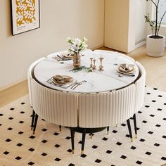 a round table with white marble top and black metal legs in a living room setting