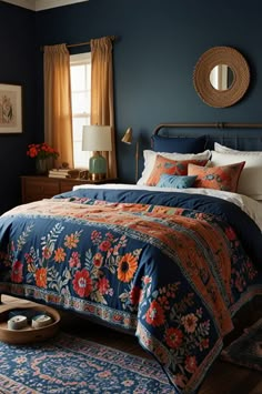 a bed in a bedroom with blue walls and floral bedspread on top of it