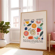 an art print with fruit on it in front of a window and potted plant