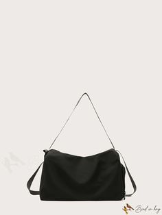 a black handbag on a white background with the strap hanging down to it's side