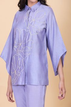 Lilac concealed placket shirt with abstract flower embroidery. Comes with pant.
Components: 2
Pattern: Embroidery
Type Of Work: Flower
Neckline: Collar
Sleeve Type: Bell
Fabric: All weather pure silk
Color: Purple
Other Details: 
Hand-spun and handwoven
Weight (in kgs): 0.8
Shirt:
Shirt collar with hidden placket
Pant:
Elasticated back with a concealed drawstring in the front
Straight silhouette
Ankle length
Occasion: Work - Aza Fashions Designer Long Sleeve Sets For Spring, Spring Silk Tops With Set-in Sleeves, Designer Sets For Spring, Designer Embroidered Sets For Spring, Lunch Dresses, Co Ords Outfits, Embellished Shirt, Mens Fashion Wear, Crochet Hair Accessories