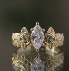 a close up of a ring with a rose on it