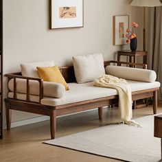 a living room with a white couch and wooden furniture