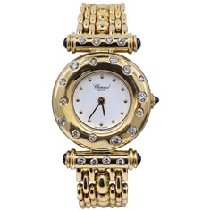 This beautiful, hard-to-find late 20th century timepiece features a round white face with gold dot hours within a wide, rounded bezel punctuated with clean white diamonds. The Imperiale-style lug bars are also set with diamonds. The crown and the ends of the lug bars are tipped with sapphire cabochons. The heavy link band is solid 18 karat yellow gold. The original box is included. A distinctive and elegant piece of jewelry, as well as a superbly crafted timepiece. Case size: 23.3mm Case thickne Luxury Vintage Yellow Gold Jewelry, Luxury Vintage Round Watches, Luxury Vintage Gold Chronograph Watch, Stone Case, Chopard Jewelry, Chopard Watch, Gold Diamond Watches, Jewelry Promotion, Nail Jewels