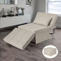 a white reclining chair sitting on top of a hard wood floor next to a window