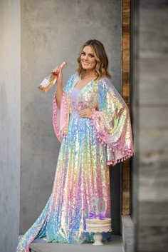 Our beautiful “Rainbow Disco" gown was designed after our own designers love for bohemian vibes and all things lace. This gorgeous gown is made with a beautiful pastel sequin fabric. We have added an elastic waist to the dress which adds extra sizing capabilities. Flair sleeves adorned with pink tassels. We have also added tassels to her back of bodice. This dress can easily size up and down. Dress comes with a detachable slip-Slip is exact measurements provided-so there is no give/stretch. You Up And Down Dress, 70s Fashion Women, Flair Sleeves, Holographic Dress, Thrift Store Clothes, Fairytale Fashion, Bohemian Vibes, Rainbow Dress, Sequin Fabric