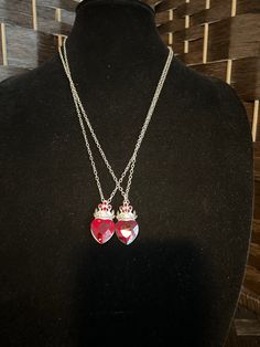 "Be the princess you are with this Red Rhinestone Heart Necklace With Crown! This funky Necklace features a large red heart-shaped crystal with an antique and red crystal crown on top that is on a chain necklace. There shade of the stone varies. Add this unique necklace to your jewelry collection and you will turn into the queen you are. Details: Length: 24\" Width: 0.75\" Metal Color: Silver Great gift for any special occasions. This beautiful red princess heart necklace is ready to ship and wi Red Necklaces For Mother's Day Party, Red Necklace For Mother's Day Party, Red Heart Charm Necklace For Wedding, Red Jeweled Jewelry For Valentine's Day, Red Jewels Jewelry For Valentine's Day, Red Valentine's Day Jewelry, Mother's Day Red Party Necklaces, Red Heart Cut Necklace For Party, Red Heart Cut Necklace For Wedding