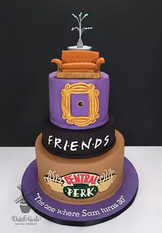 there is a three tiered cake that has friends on the top and bottom layers