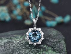 ***This gorgeous London blue topaz necklace features a 14k rose gold chain and round London blue topaz with a diamond halo design, brilliant and shiny. Perfect for various occasions with a variety of gorgeous dresses***- Metal: Solid gold(9K/14K/18K white/yellow/rose gold),925 sterling silver, platinum available- Main Stone: 8mm natural London blue topaz- Accent Stone: diamonds or moissanites- Chain: 16+2 inches. The chain can be adjustable to 18 Inches.- Can be personalized: Yes Diamond Gemstone Flower Pendant Jewelry, Diamond Flower Pendant Jewelry With Gemstone, Sapphire Jewelry With Prong Setting As Gift, Exquisite Sapphire Round Necklaces, Dainty Sapphire Diamond Jewelry, Sapphire Jewelry With Diamond Accents Round Cut, Blue Topaz Jewelry With Diamond Accents, Round Cut, Diamond Gemstone Jewelry As Gift For Her, Sapphire Color Jewelry With Diamond Accents