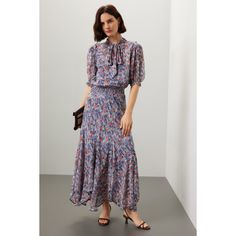 Blue floral cotton (100% Viscose). A-line. Short sleeves. Tie neck. Pull on. 53" from shoulder to hemline. Imported. Knee-length Flowy Midi Dress With Floral Print, Knee-length Floral Midi Dress With Flowy Skirt, Blue A-line Dress With Flowy Skirt, Floral Print A-line Maxi Dress With Flowy Skirt, Floral Print A-line Flowy Maxi Dress, Flowy A-line Maxi Dress With Floral Print, Blue Flowy Feminine Dress, Feminine Blue Dress With Flowy Skirt, Feminine Blue Flowy Dress