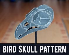 the bird skull pattern is cut out and placed on top of a wooden table with text overlay