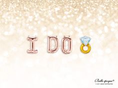 the word i do spelled with two rings in front of a glittery white background