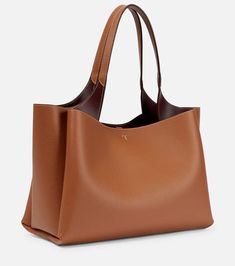 Tod's - Medium leather tote bag | Mytheresa Timeless Tan Shoulder Bag For Everyday Use, Timeless Tan Satchel For Everyday Use, Tan Textured Leather Tote Satchel, Tan Tote Satchel For Work, Tan Workwear Tote Satchel, Tan Textured Leather Shoulder Bag For Daily Use, Timeless Tan Textured Leather Bags, Timeless Tan Bags With Leather Handles, Tan Textured Leather Tote Bag