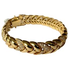 By Swiss designer Gübelin, this 18 K yellow Gold bracelet with a classic and timeless design is set with 182 brilliant cut Diamonds weighing approximately 2 ct, G color, vs clarity. The length is 19 cm the width is 1.2 cm and the bracelet weighs 63.17 grams. This is a great bracelet for everyday wear. Masterfully handcrafted piece! Authenticity and money back is guaranteed. For any enquires, please contact the seller through the message center. Luxury Statement Yellow Gold Diamond Bracelet, Luxury 22k Gold Yellow Bracelet, Luxury Yellow Gold Symbolic Bracelets, Luxury Vintage Gold Bracelet As A Gift, Luxury Yellow Fine Jewelry Bracelets, Luxury Diamond Bracelet In Yellow Gold, Luxury Yellow Gold Bracelet With Intricate Design, Luxury Yellow Gold Diamond Chain Bracelet, Luxury Yellow Gold Ornate Bracelet