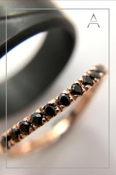 a black diamond ring sitting on top of a table