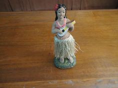 a figurine is sitting on a wooden table