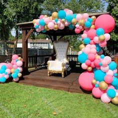 a gazebo decorated with balloons for a baby shower