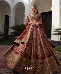 a woman in a red and gold bridal gown