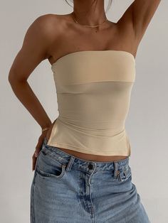 DETAILS: Our Nina Nude Tube Top, a wardrobe staple designed for both style and comfort. Crafted from soft fabric with ample stretch, this fitted tube top ensures a comfortable and flattering fit for all-day wear. Enhance your silhouette with the side ruching detail, which adds a touch of elegance and creates a flattering look. Versatile and chic, the Nina Nude Tube Top is perfect for layering or wearing on its own, making it a must-have piece for any fashion-forward wardrobe. CONTENT & CARE: 50% Cream Tube Top Outfit, Beige Tube Top Outfit, Tube Top Outfits, Senior Fashion, Spring Essentials, Women's Outfit Sets, Simple Fits, Fall 23, Summer Lookbook