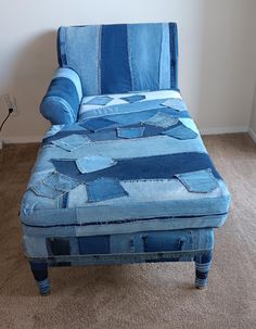 a blue chaise lounge chair sitting on top of a carpeted floor next to a wall