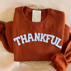 Cozy up with our Thankful Crewneck Sweatshirt this fall season!  - Sweatshirt is super soft and comfy! ♡ - Sweatshirt composition: 50% cotton, 50% polyester - All our sweatshirts run a unisex fit. They are naturally oversized, so we normally recommend your true size. But if you like a more baggy look, we recommend sizing up. - These letters are iron-on patched and is heat pressed, not embroidered. But rest assured they've been tested and won't fall off! - Please note that crewneck brand used may Fall Loungewear T-shirt, Relaxed Fit T-shirt With Ribbed Cuffs For Fall, Everyday Fall Crew Neck Sweatshirt, Long Sleeve Fall Sweater For College, Long Sleeve Sweater For College In Fall, College Letter Print T-shirt For Fall, Comfy Fall Tops, Comfy Tops For Fall, Cozy Letter Print Tops For Fall