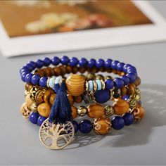 Experience Gorgeous, Unique Style With The Tree Of Life Bracelet 4 Piece Set! This Vibrant Set Is Intricately Crafted With Four Distinct Pieces, Each Adorned With An Eye-Catching Tree Of Life Design. Accessorize Your Wardrobe With A Touch Of Flair And Express In A Way You Never Thought Possible! - Vintage Wooden Bead Multi-Layer Bracelet - Fashion And Elegant Design - Exquisite Beaded Bracelet Is The Adornment Of The Women, It Will Add Shine To Your Appearance. - Elastic, Multi-Layer, Wooden-Bea Blue Wooden Beaded Bracelets For Beach, Bohemian Blue Bracelets With Wooden Beads, Bohemian Blue Beaded Bracelets With Wooden Beads, Blue Bohemian Beaded Bracelets With Wooden Beads, Blue Wooden Beads Bracelet, Hippie Brown Beaded Bracelets, Blue Bohemian Beaded Bracelets With Large Beads, Bohemian Blue Bracelets With 8mm Beads, Hippie Blue Round Bead Bracelets