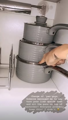 a woman is reaching into the sink to get some food