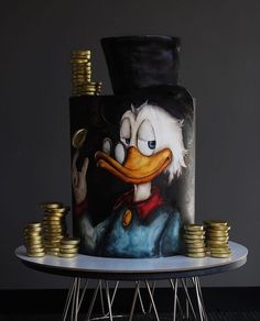 a cake decorated with donald the duck and stacks of gold coins