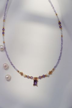 This exquisite necklace featuring a delicate string of amethyst gemstones and radiant freshwater pearls, the centerpiece is a stunning purple CZ amethyst gem framed by intricate gold detailing. Our fine craftsmanship ensures each detail is carefully placed, from the shimmering gold accents to the luminous pearls, making this piece an ideal choice for someone who appreciates refined elegance and unique designs. Treat yourself or a loved one to this beautiful piece today! Details 4*6mm amethyst CZ Elegant Purple Crystal Necklace With Gemstone Accents, Elegant Amethyst Crystal Necklace With Gemstone Accents, Purple Amethyst Necklace With Gemstone Accents, Delicate Purple Gemstone Jewelry, Purple Crystal Necklaces With Gemstone Accents, Purple Crystal Necklaces With Gemstone Accents For Jewelry Making, Purple Crystal Necklace For Jewelry Making, Lavender Necklace With Faceted Beads Gift, Lavender Faceted Beads Necklace For Gifts