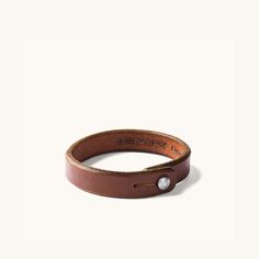 Description Constructed from the same leather used in our belts, our Single Wrap Wristband is a great option for those who don’t want to sport a lot of adornment. A simple leather band, we feel, is the perfect accent. Wristband Sizing Small/Medium: 7.75" in length, 15-15.5cm circumference Large/XLarge: 8.25" in length, 16-16.5cm circumference Width: .5" Details Constructed from 9-10oz. weights of the same Natural tooling leather used in our belts, each is punched out of a single strip of leather Simple Leather Bracelet, Leather Wristband, Leather Wristbands, Simple Leather, Leather Cuts, Genuine Leather Wallets, Leather Projects, Leather Bracelets, Wristbands