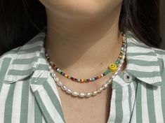 This beaded necklace is perfect for brightening up any outfit! Dress it up for a more elegant night out, or wear it casually for a chic, beachy look. Perfect for the summer months or a touch of fun during an overcast winter day. This necklace is made out of 6mm  yellow happy face beads and rainbow seed beads, finished with silver hardware. Necklace Length: 14.5 inches- We add a 2in extender chain at the end to make the necklace adjustable (14.5 inches - 16.5 inches)- If you would like a differen Hardware Necklace, Pearl Beaded Necklace, Single And Happy, Summer Necklace, Outfit Dress, Necklace Pearl, Necklace Beaded, Cute Necklace, Summer Months