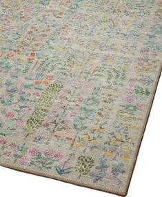 an area rug with colorful flowers and leaves on the bottom, in various shades of green