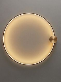 an illuminated circular light fixture on the wall