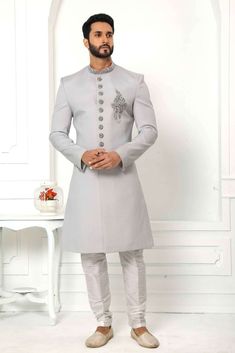 It is Set of Mens Indo Sherwani with churidar in grey color with handwork button and chest . it Outfit designed for looking dashing in party event wedding function. It Contain- 1 Indo Western + 1 Churidar Work Enhancement - Hand work Button and chest and coller work  Size Available ( Inches )-  34 | 36 | 38 | 40 | 42 | 44 | 46 | 48 | 50 | 52 | 54 | 56 | 58 Color- Light grey Fabric- -Indo western-Teri Rayon                Churidar- Art Silk Note- its make to order and Please mention Proper guidan Silver Kurta With Zari Work For Wedding, Silver Wedding Kurta With Zari Work, Bollywood Style Silver Kurta For Wedding, Silver Wedding Kurta, Festive Silver Wedding Kurta, Bollywood Style Silver Kurta For Diwali, Silver Bollywood Kurta For Diwali, Silver Sherwani For Eid Wedding, Silver Sherwani For Wedding And Eid