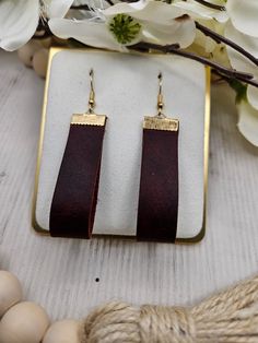 Beautiful, fun genuine leather earrings. Perfect for everyday wear or special occasions. You will love these trendy, genuine leather earrings. Each pair is handmade by us with lead free, stainless steel hooks. They hang at approximately 2.5 inches for the perfect everyday look. All earrings may vary slightly due to leather patterns. Colors may vary slightly due to screen variations. Brown Rectangular Jewelry, Everyday Brown Leather Strap Jewelry, Brown Rectangular Earrings With Ear Wire, Everyday Leather Jewelry In Rectangular Shape, Brown Rectangular Leather Jewelry, Everyday Rectangular Leather Jewelry, Rectangular Leather Fashion Jewelry, Brown Leather Rectangular Jewelry, Trendy Brown Rectangular Jewelry