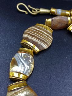 The Rare Unique Bactrian Banded Agate Beads Necklace Circa Late 3RD-EARLY 2ND MILLENNIUM B.C very rare Beads from my Old Collections very rich in patina (rust) Every Bead Got very Big hole The Age of this Beads are more than 2000 Years Old They were used as a special charm Jewelry At that Ancient Times Best gift for the people who collect Ancient Beads and study ancient history Fast and Free Shipping Service World Wide Enjoy Luxury Natural Gemstones, Artisan Gold Beads, Gems, And Cabochons, Artisan Gold Gemstone Beads And Cabochons, Gold Agate Beads For Jewelry Making, Gold Agate Round Beaded Necklaces, Luxury Agate Gemstone Beads Necklace, Gold Agate Round Beaded Necklace, Gold Agate Beaded Necklaces, Gold Round Agate Beaded Necklaces