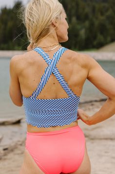 The scalloped detail will have you loving this sporty but feminine design. This crop was our Best-selling top of 2019! It is a bit longer than our other crops and when paired with our high-rise bottoms it gives you the illusion of a one-piece look with the convenience and comfort of a two-piece! You will have a blast Mix and Matching this with all of our bottoms. Due to the large influx of orders with the launch of this new collection, we ask that you allow 3-5 business days for these items to s Crop Swim Top, Athletic Clothing, Workout Clothing, White Leopard, I Wish I Was, Feminine Design, New Launch, Athletic Outfits, Clothing Inspiration