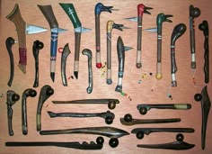 many different types of knives and spoons on a table